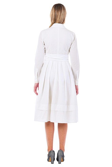 Our cotton poplin shirtdress with a surplice V-neck is cinched with a wide obi sash belt and tailored with inverted pleats for a full skirt. 