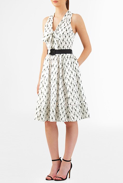 Our giraffe print cotton dress styled with a trend right neck-tie to top the ultrafemme style, is cinched in with a removable poplin belt and finished with lattice trim at the hem.