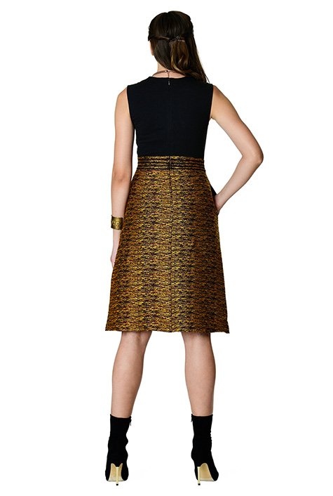 Our mixed media dress features a cotton knit bodice and a floral embellished gold tweed skirt with stripe lace trim at the banded waist.