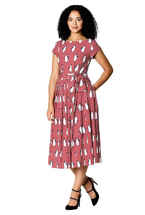 A wide sash tie belt cinching in the high banded waist accentuates the flattering fit-and-flare silhouette of our penguin and polka dot print crepe dress styled with an angular pleated bodice and sweeping box-pleat skirt.
