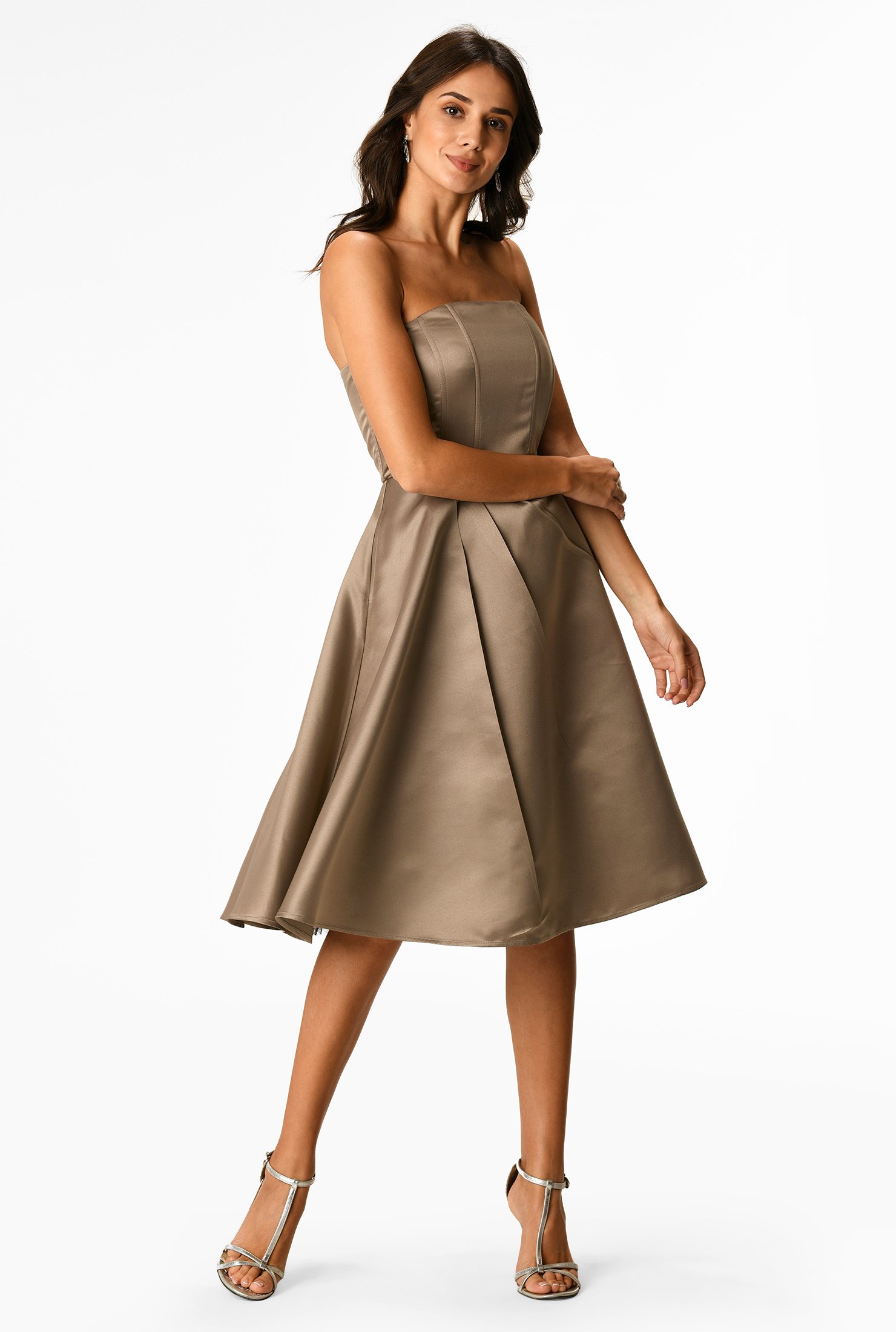Our satin dress is styled with a strapless bodice and flared out to a full skirt with asymmetric angled pleats.