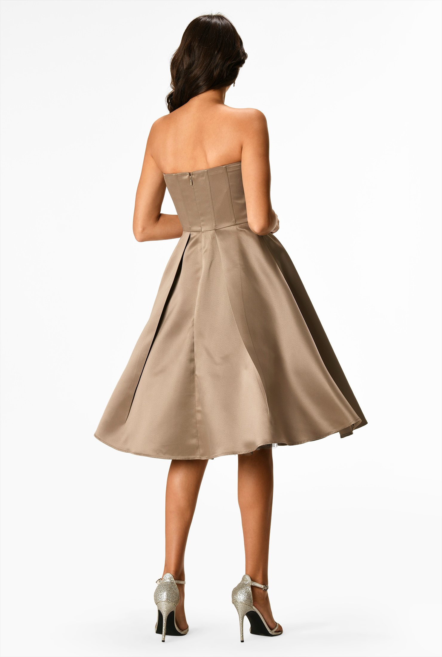 Our satin dress is styled with a strapless bodice and flared out to a full skirt with asymmetric angled pleats.