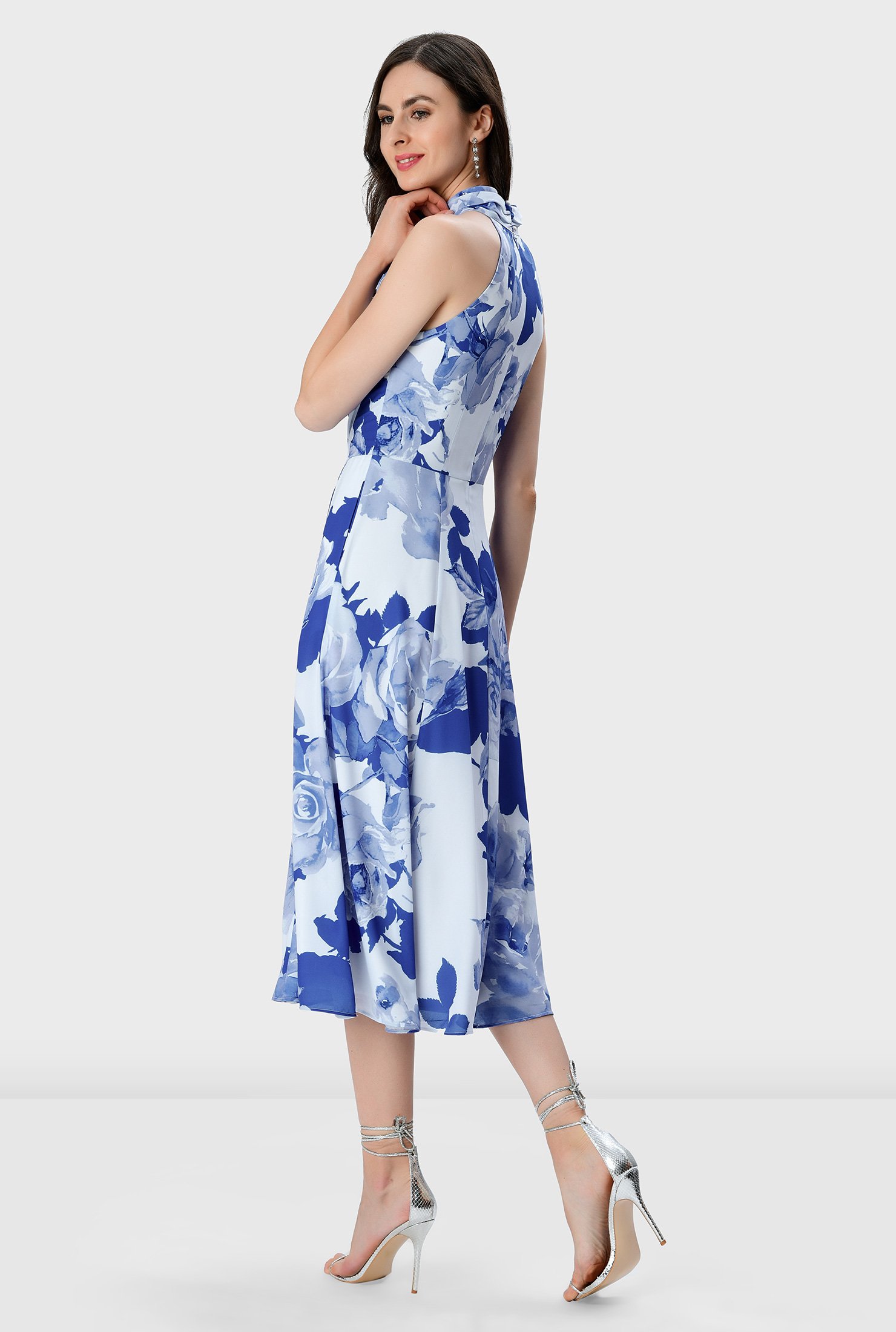 Fresh air favorite! Feel the breeze and the sun on your shoulders in our watercolor rose print crepe dress with a halter neck and a criss-cross front atop a full flare skirt that makes it a perfect choice for an unforgettable party.