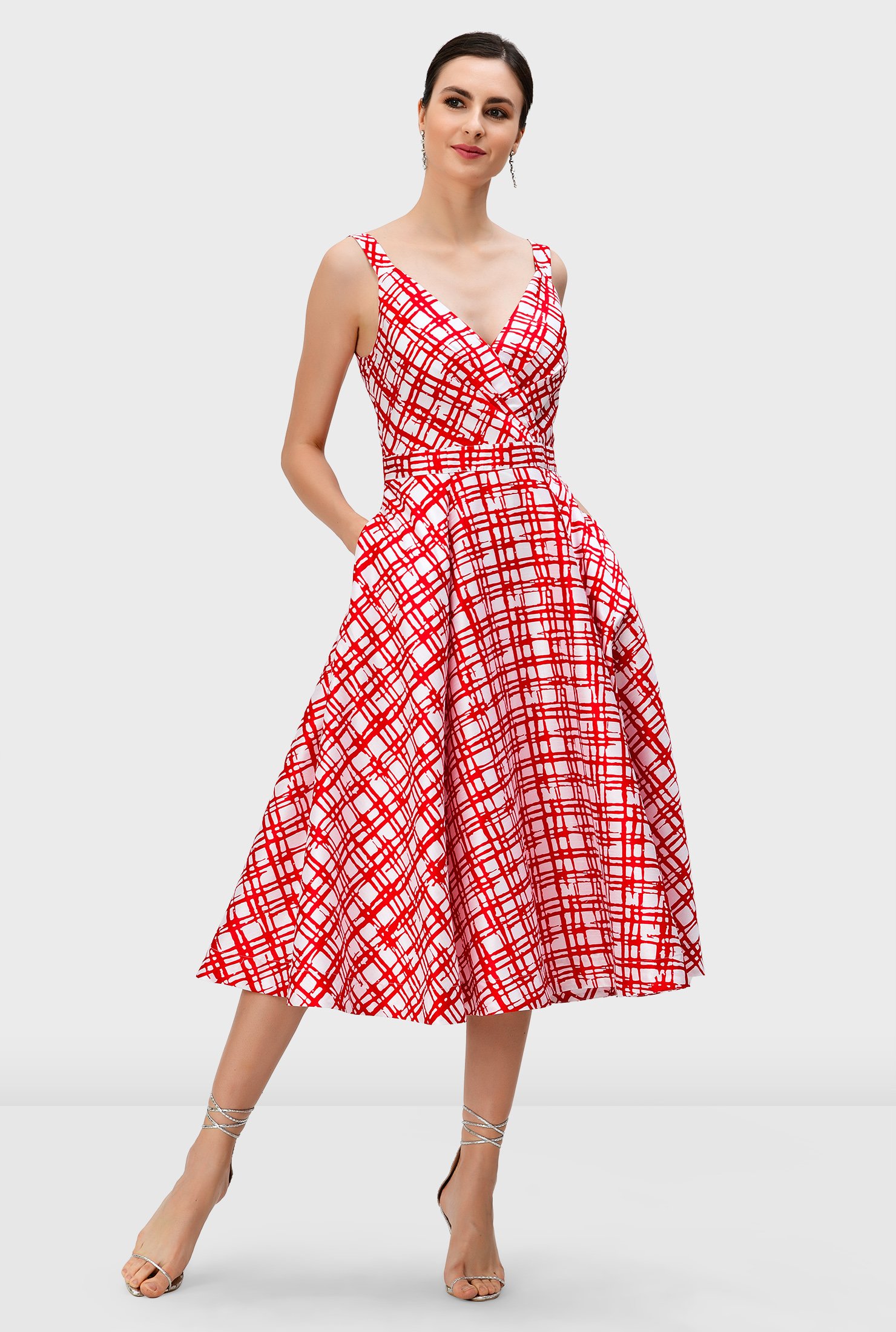 Our fit-and-flare dress in check-print dupioni is styled with a full skirt for that feminine swish, while a pleated surplice bodice creates a flattering shape.