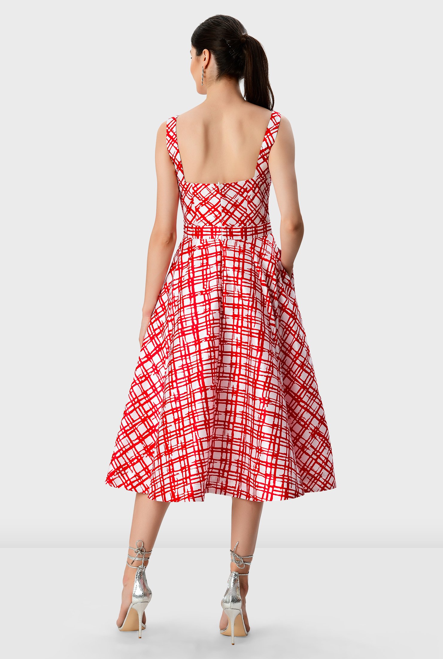 Our fit-and-flare dress in check-print dupioni is styled with a full skirt for that feminine swish, while a pleated surplice bodice creates a flattering shape.