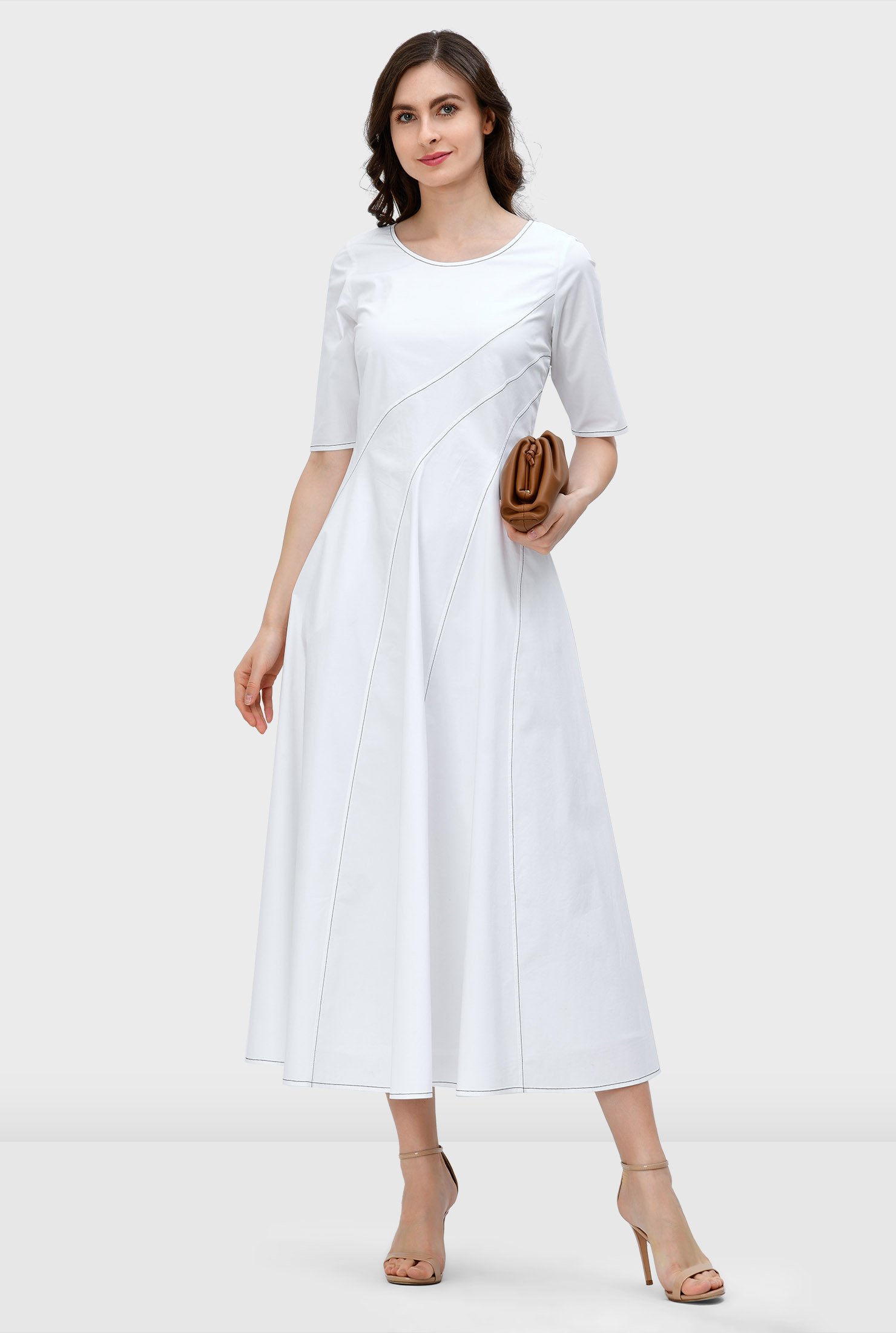 Our crisp cotton poplin dress is designed to flatter and enhance with asymmetric seams from the top to the full flare skirt and down to the contrast top-stitched hem.
