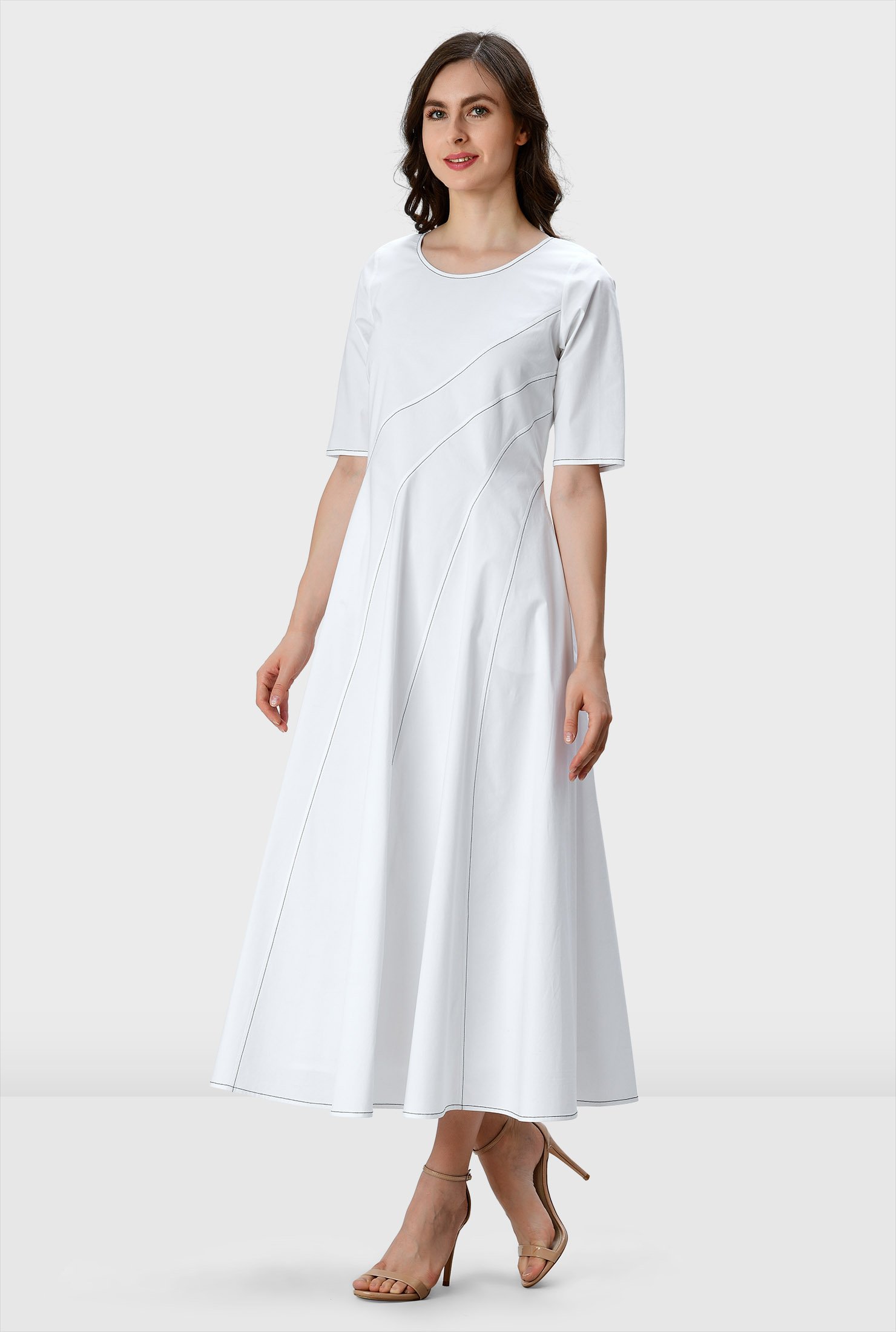Our crisp cotton poplin dress is designed to flatter and enhance with asymmetric seams from the top to the full flare skirt and down to the contrast top-stitched hem.
