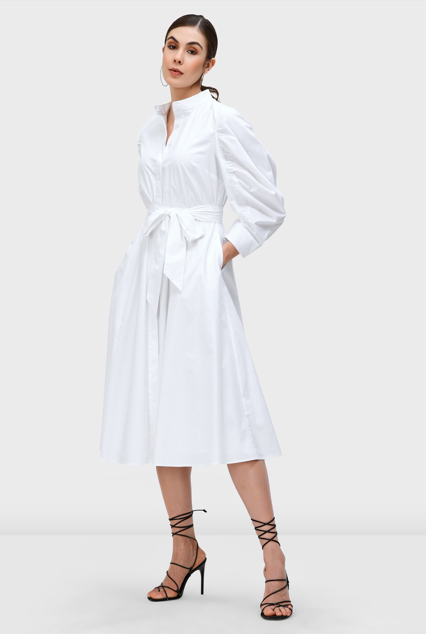 Our feminine ruched dress in crisp cotton poplin with its ruched sleeves and flair for the dramatic is cinched in with an optional self-sash-tie belt at the elastic waist. 