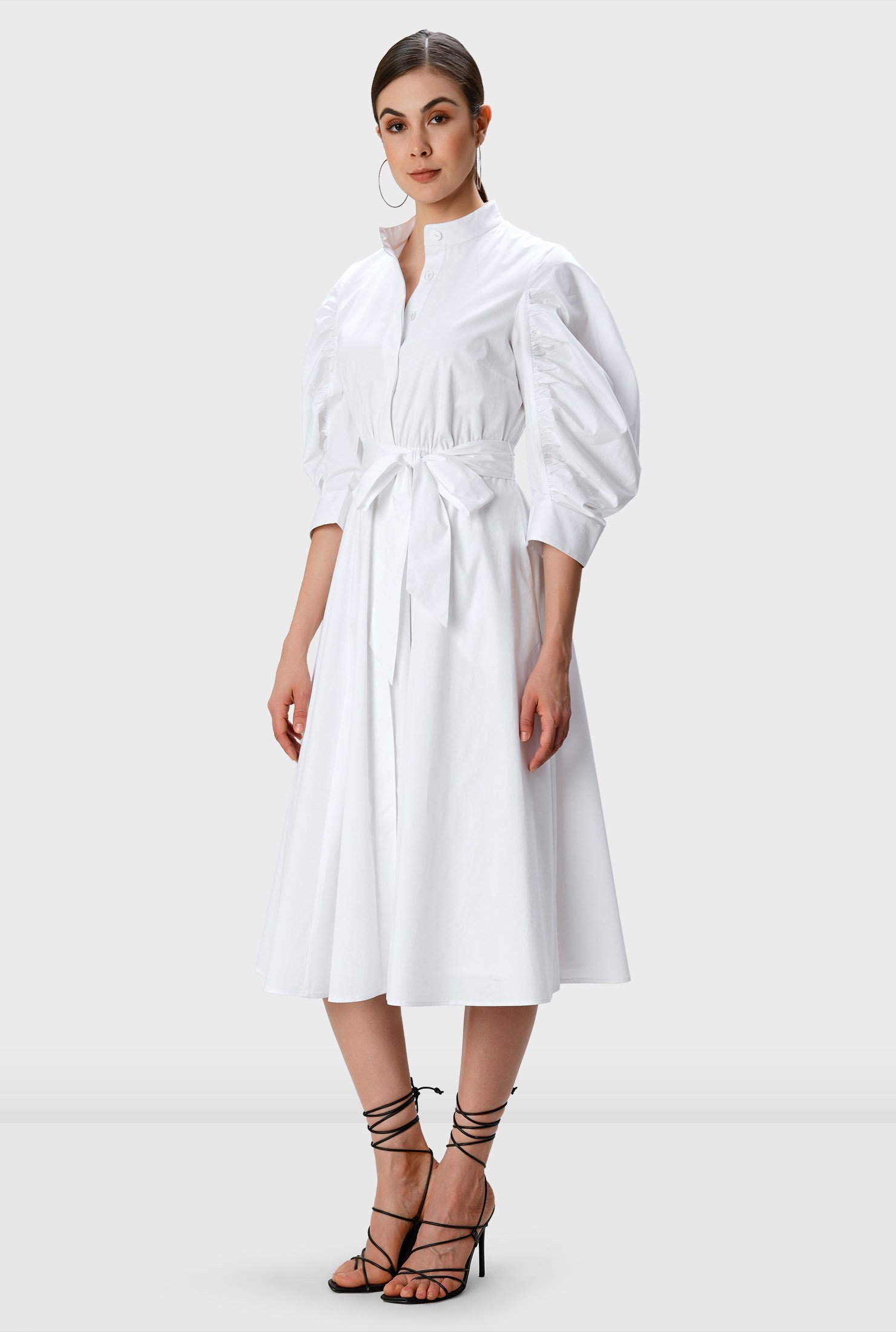 Our feminine ruched dress in crisp cotton poplin with its ruched sleeves and flair for the dramatic is cinched in with an optional self-sash-tie belt at the elastic waist. 