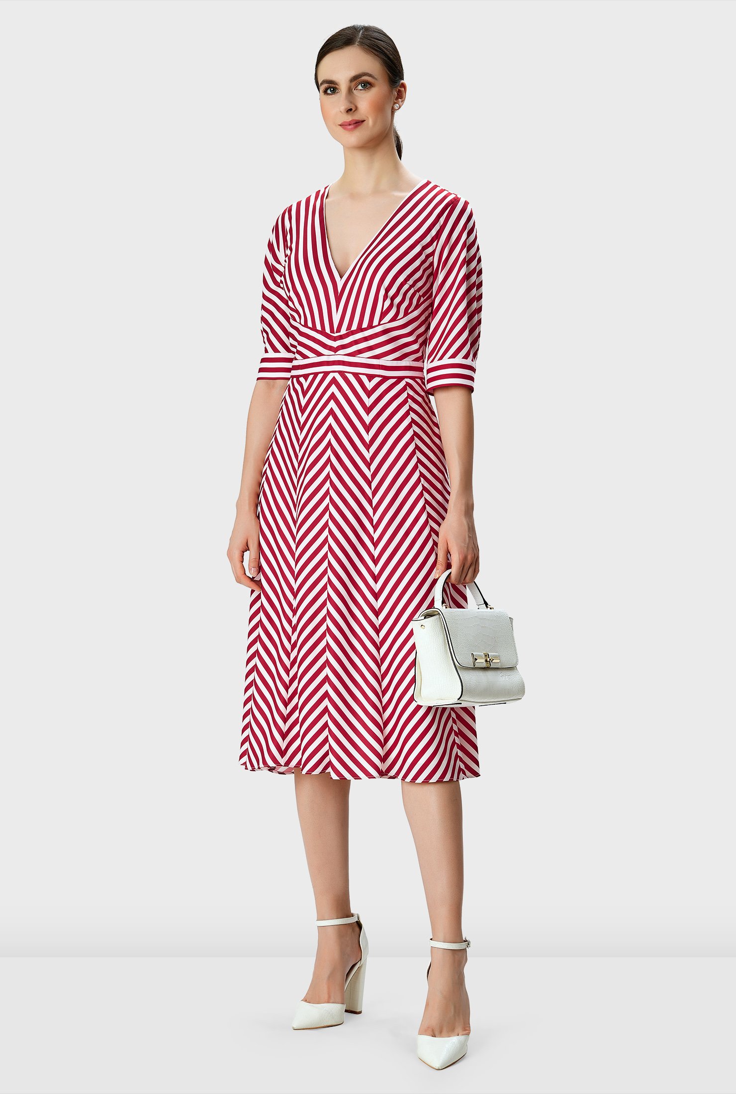 Warm spring days to summer evenings, our breezy multi-directional stripe print crepe dress for an optical illusion effect is styled with an empire bodice that flares out to a chevron stripe skirt.