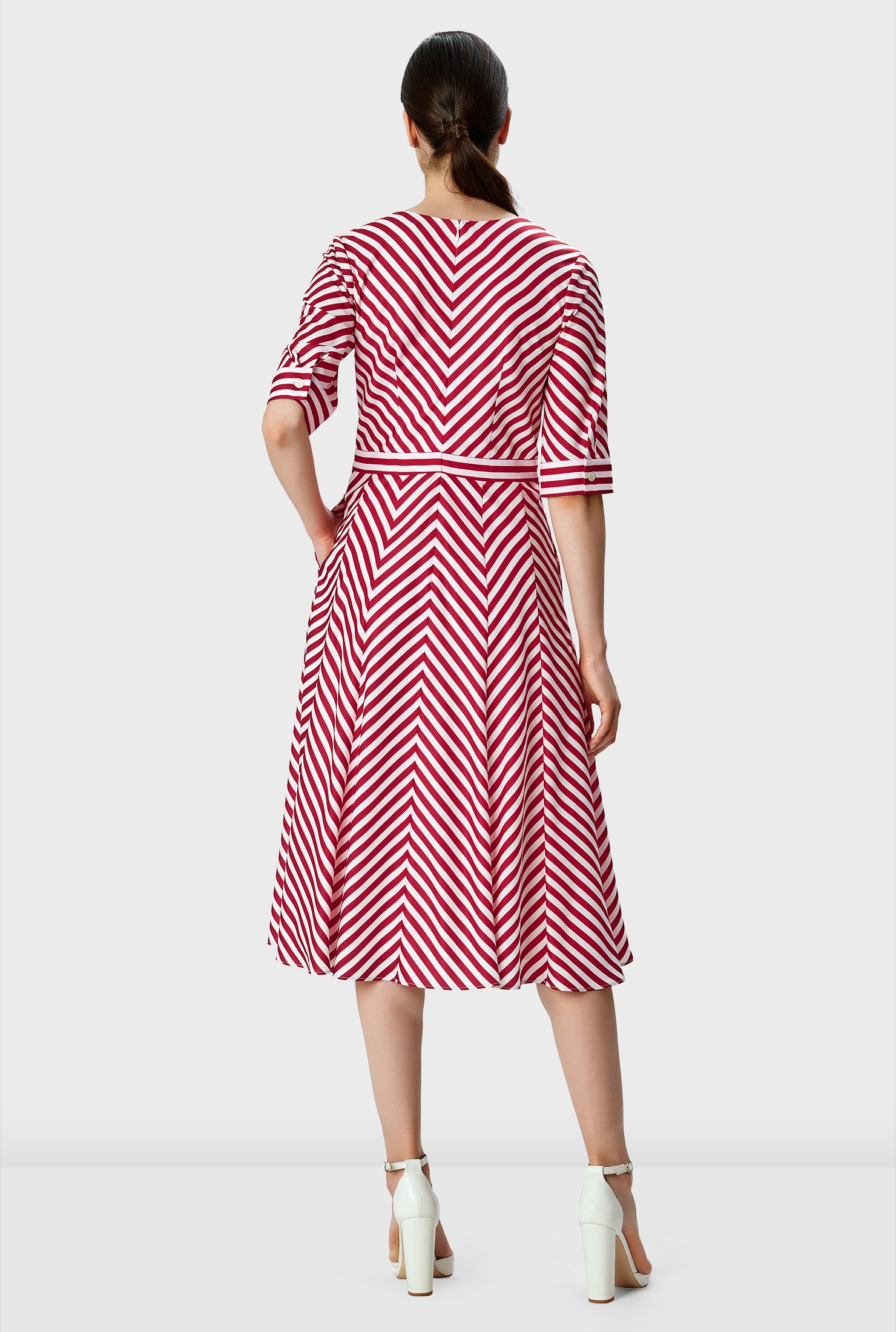 Warm spring days to summer evenings, our breezy multi-directional stripe print crepe dress for an optical illusion effect is styled with an empire bodice that flares out to a chevron stripe skirt.