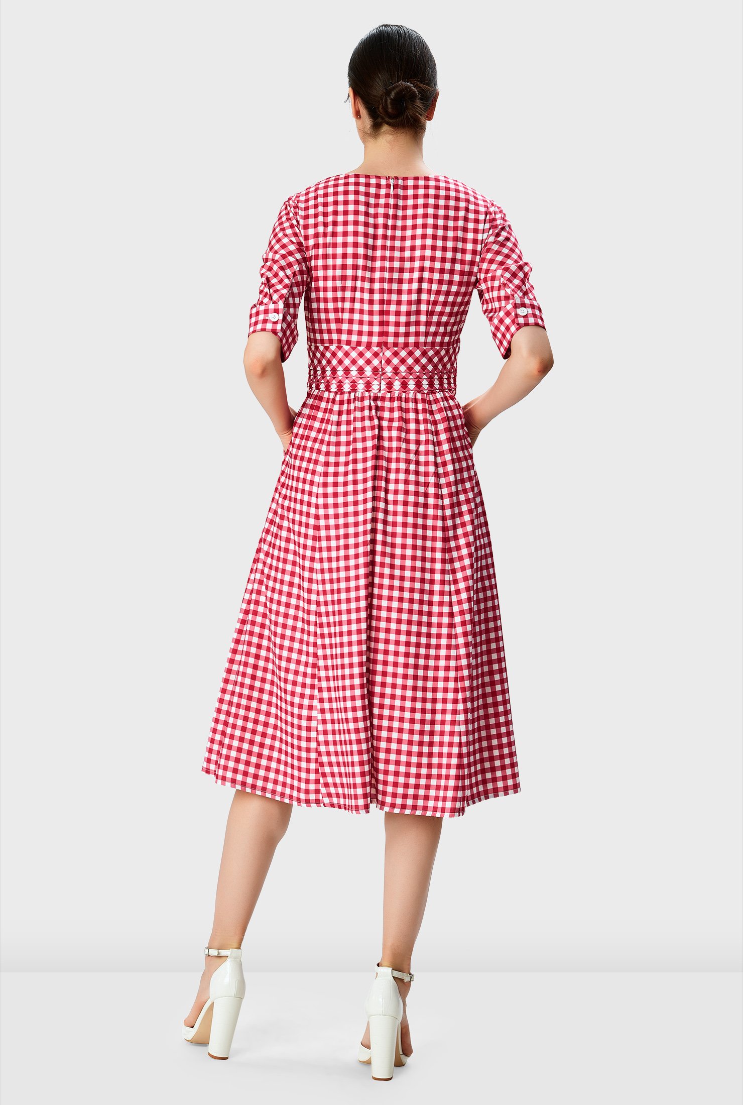 The summer dress refresh! Our gingham check print crepe dress is styled with a surplice bodice and pleated empire waist that flares out to a ruched pleat full skirt.