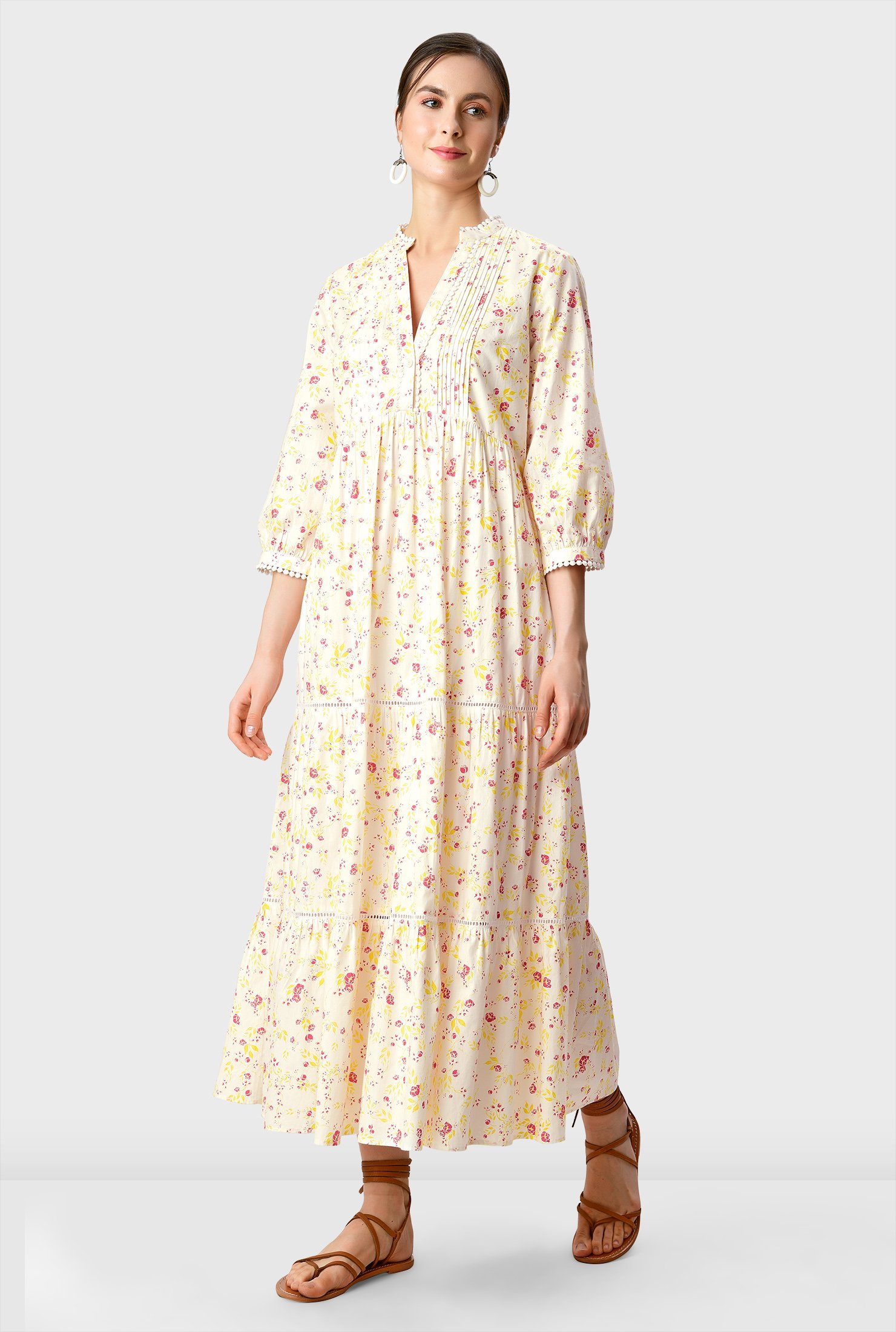 Floral print cotton poplin in a relaxed silhouette has an added twist with an optional self-sash-tie belt and a ruched pleat tier full skirt.
