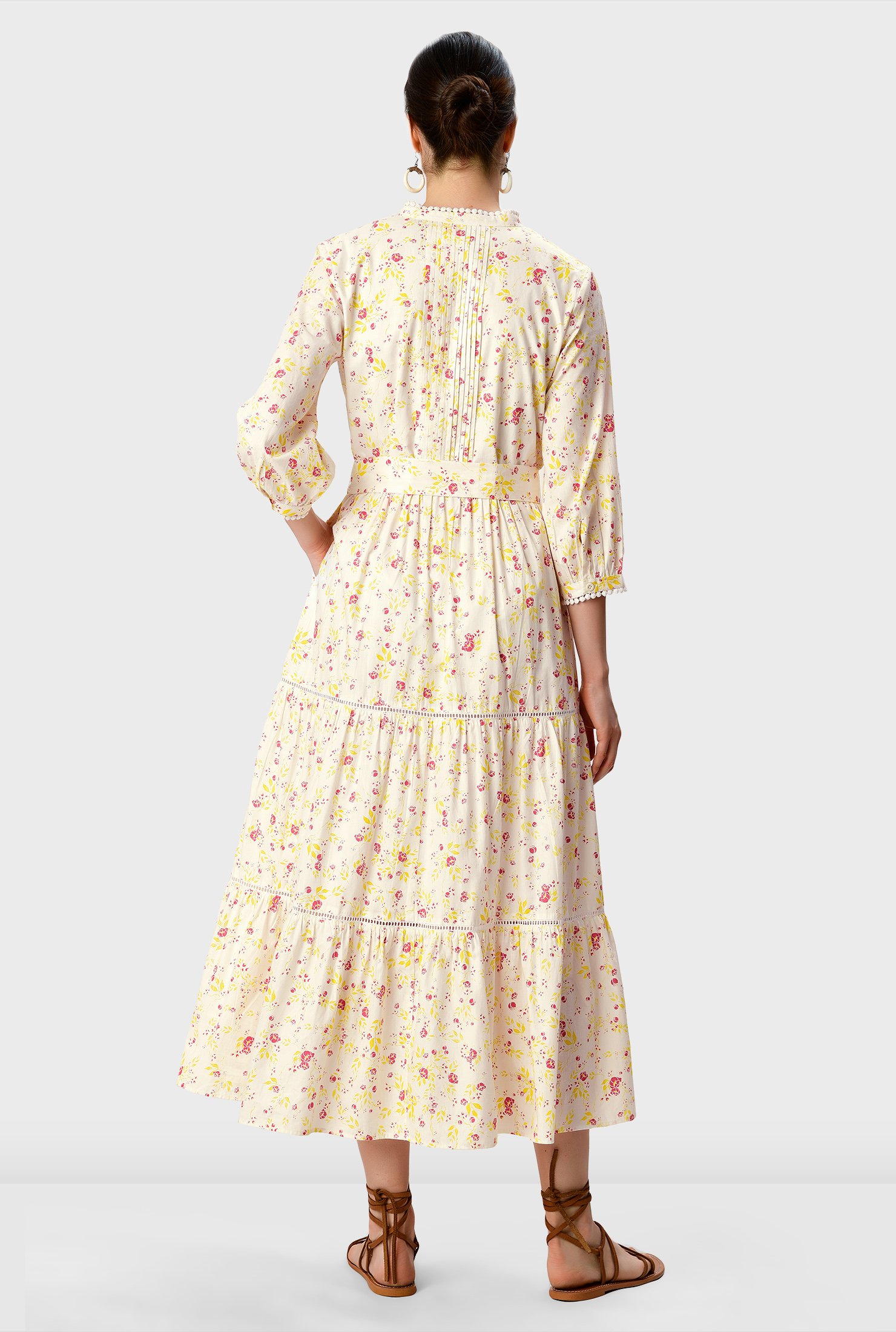 Floral print cotton poplin in a relaxed silhouette has an added twist with an optional self-sash-tie belt and a ruched pleat tier full skirt.