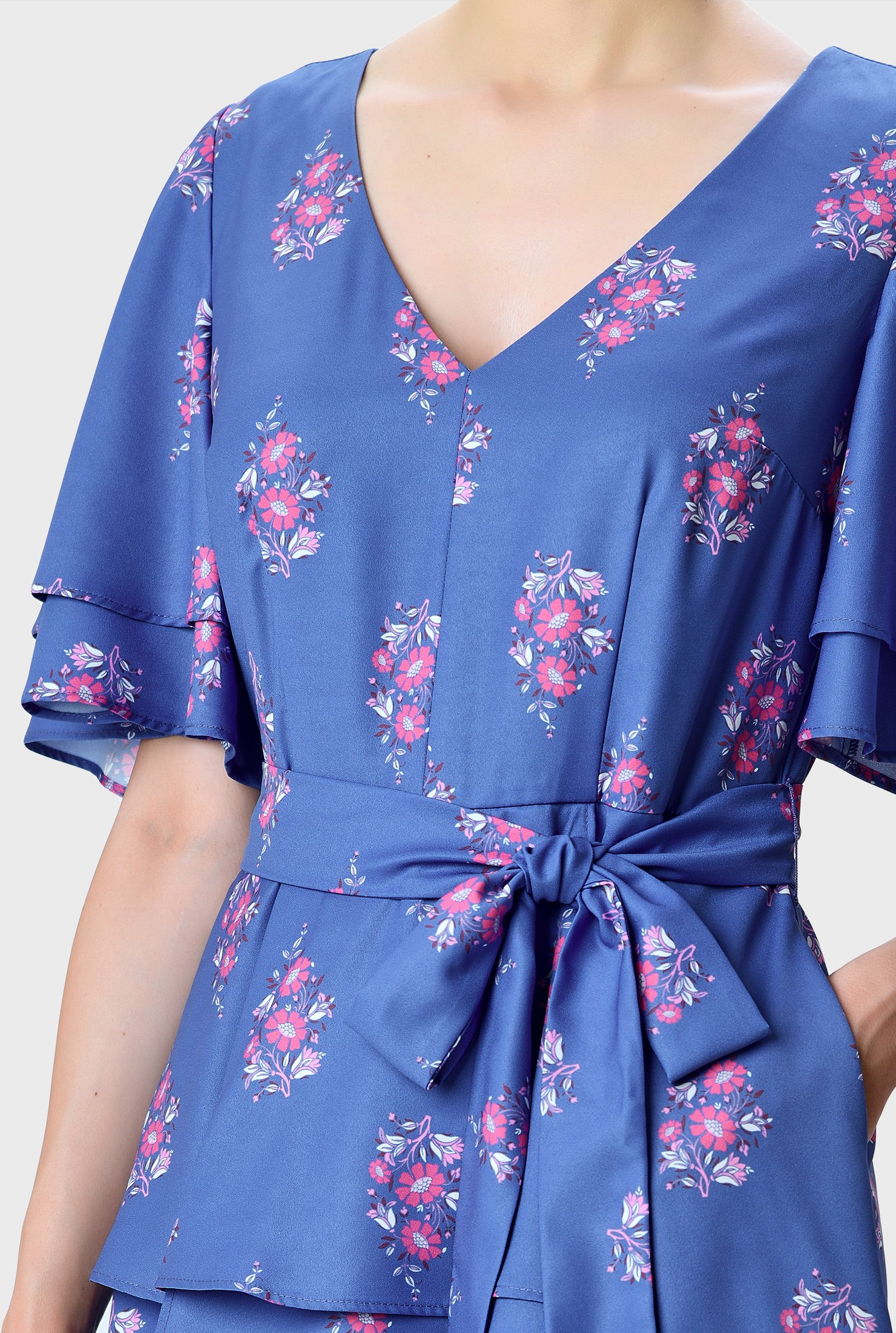 A summer stunner! Fluttering ruffles cascade down the sleeves and asymmetric tier skirt of our floral print crepe fit-and-flare dress that will bring feminine charm and a bit of romance to your upcoming events.