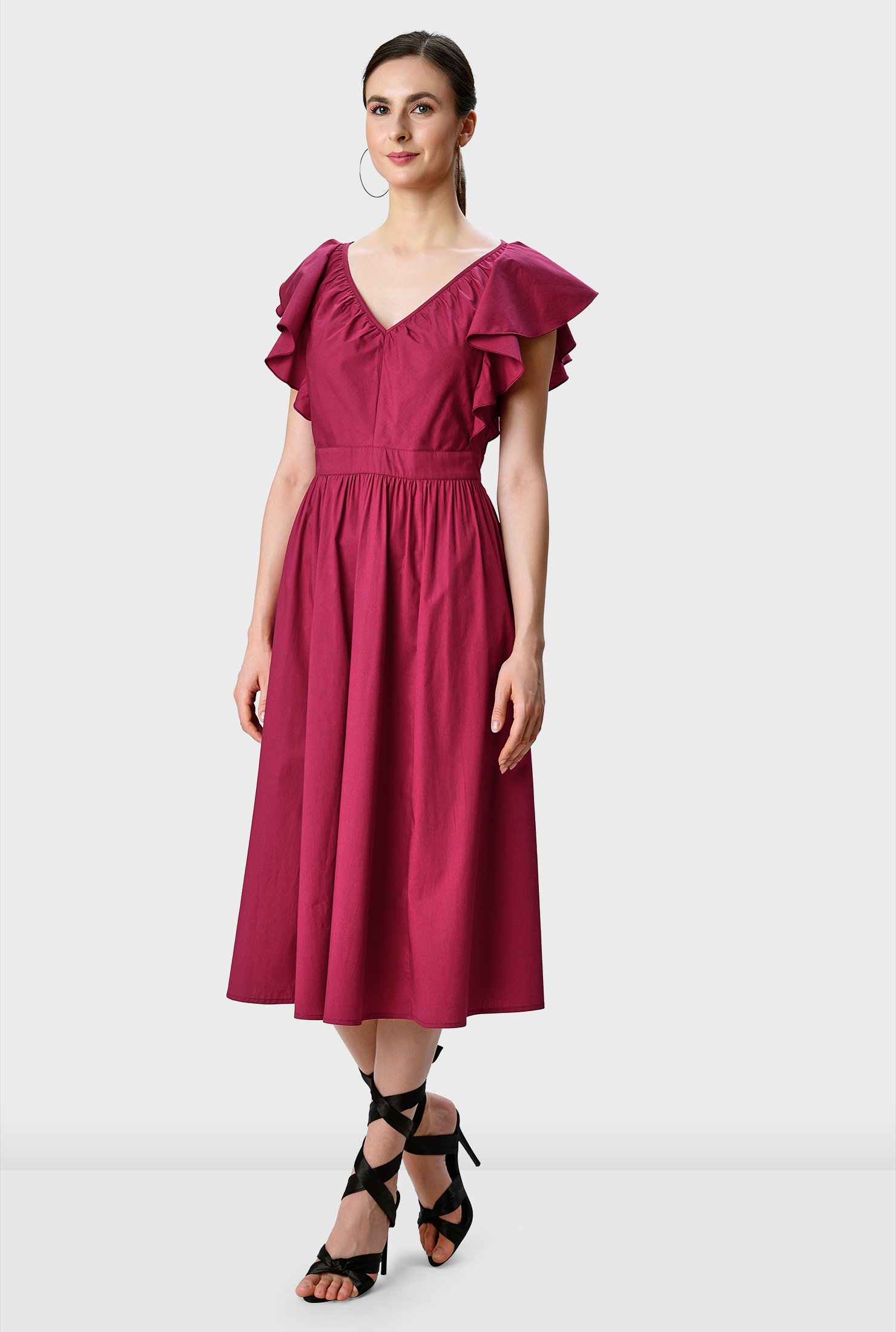 Lush ruffles spring from the shoulders down to the banded waist of our cotton poplin dress adding flutter and texture to the fit-and-flare silhouette. 