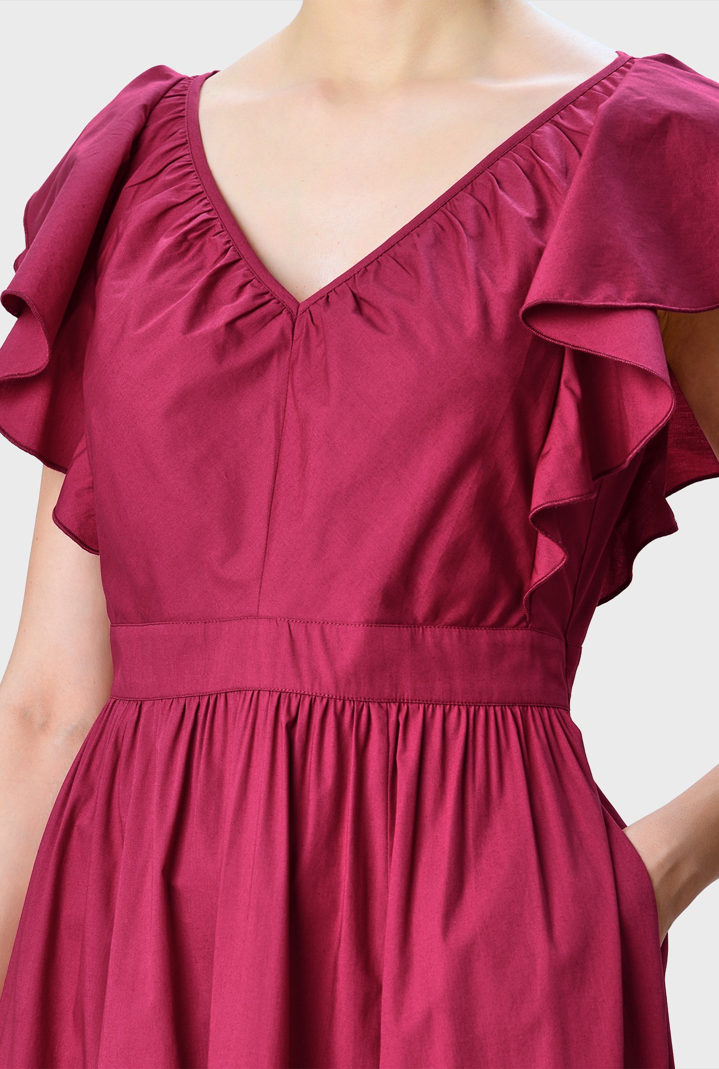 Lush ruffles spring from the shoulders down to the banded waist of our cotton poplin dress adding flutter and texture to the fit-and-flare silhouette. 