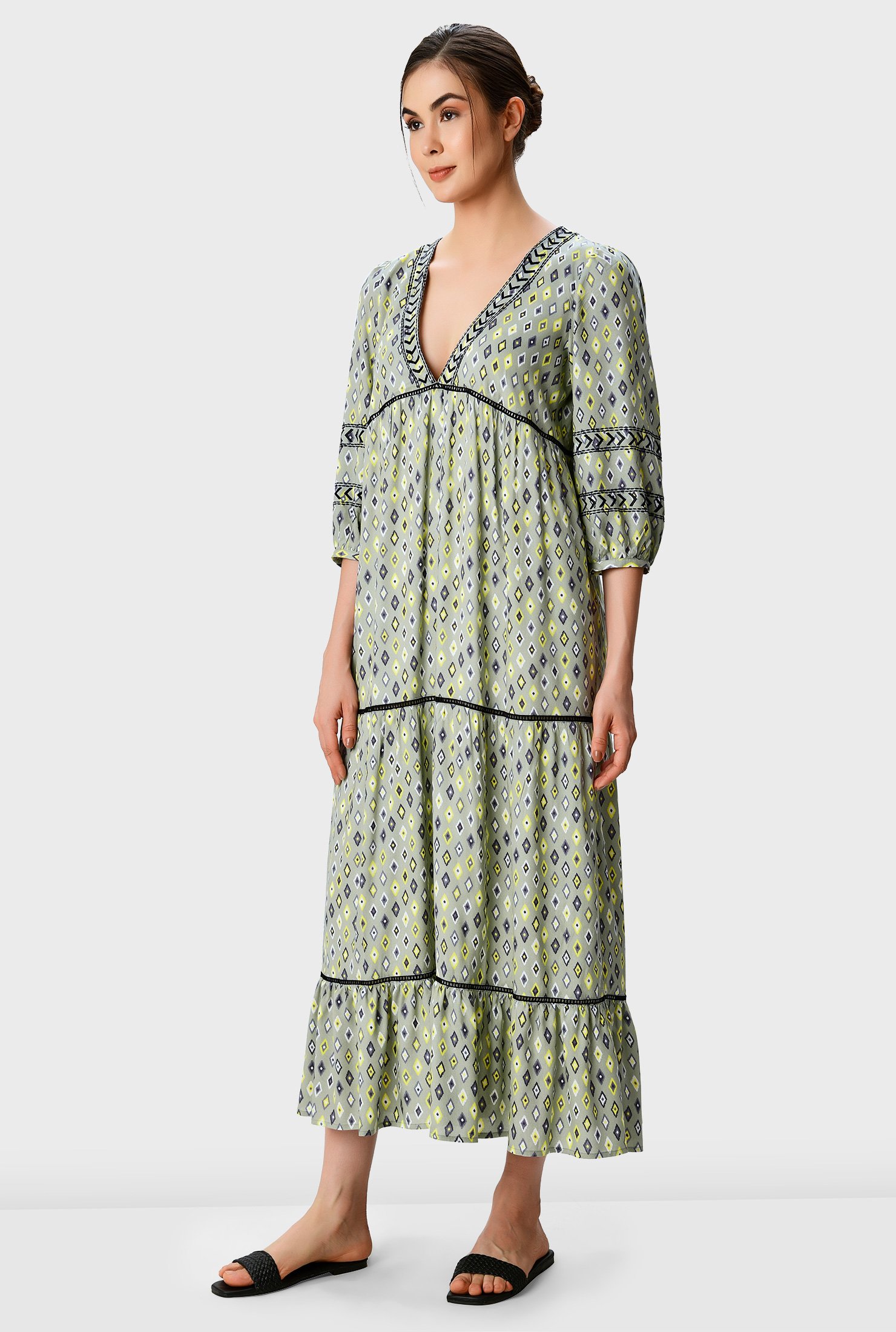 Look chic in the sunshine with our easy-breezy day dress in ikat print with graphic embroidery at the neckline and sleeves and volumized with ruched pleat tiers.