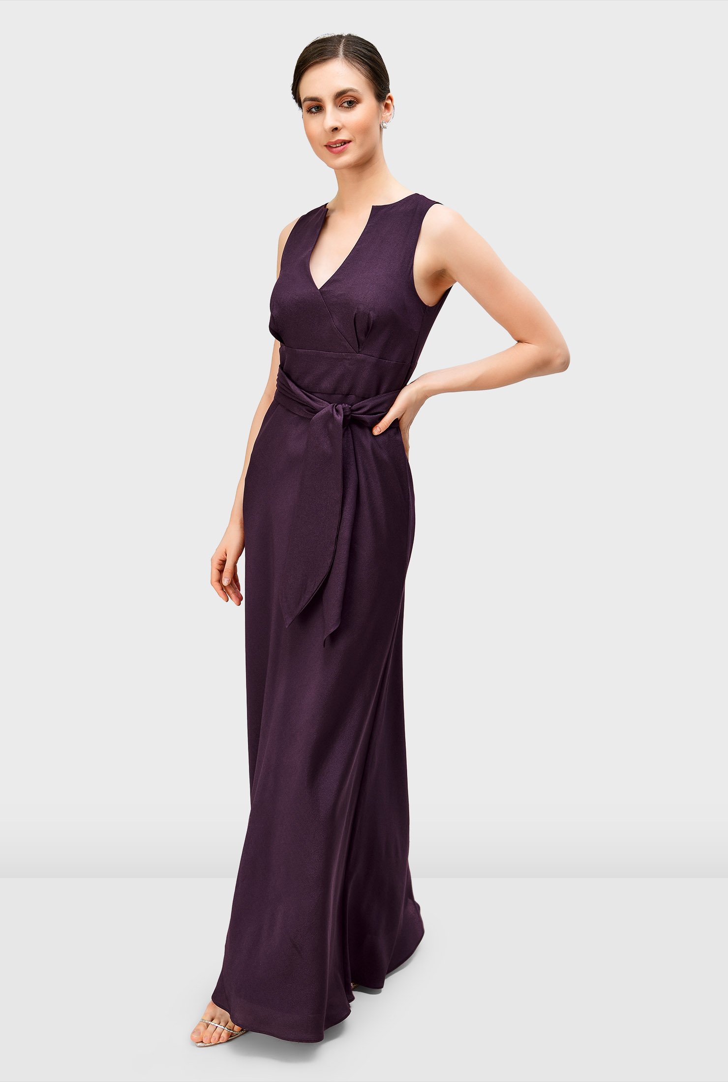 Earn the title of best-dressed wedding guest in our elegant crepe dress styled with a surplice bodice, empire waist and floor-length full flare skirt.