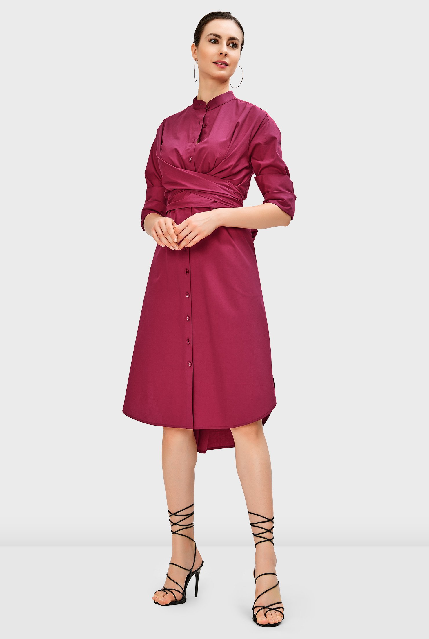 A vented high-low shirttail hem adds a bit of swing to our crisp cotton poplin shirt dress cinched in with pleated sash-ties crossed at the front and tied at the back.