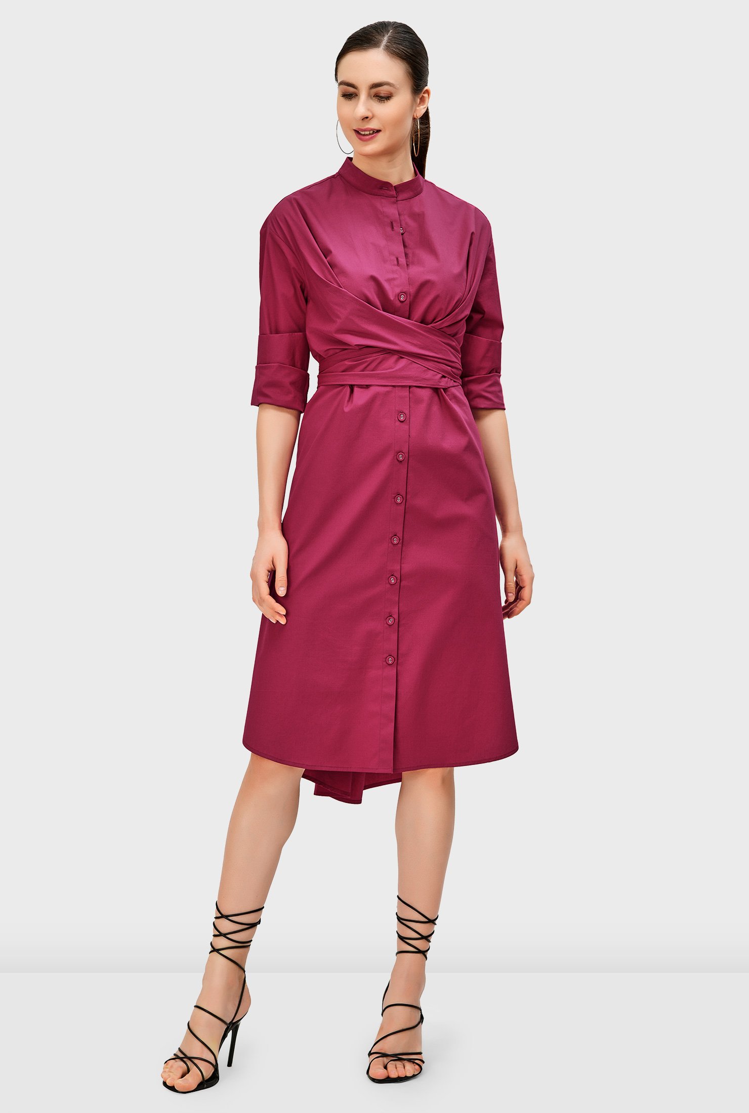 A vented high-low shirttail hem adds a bit of swing to our crisp cotton poplin shirt dress cinched in with pleated sash-ties crossed at the front and tied at the back.