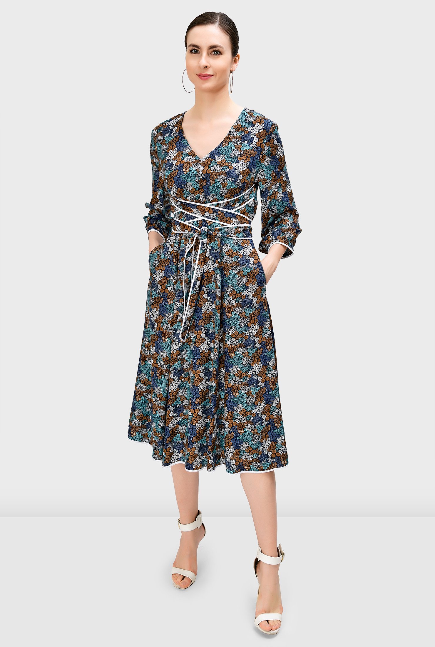 Our floral print dress is styled with attached sash ties with contrast tipped trim that wrap around the waist for a flattering finish.