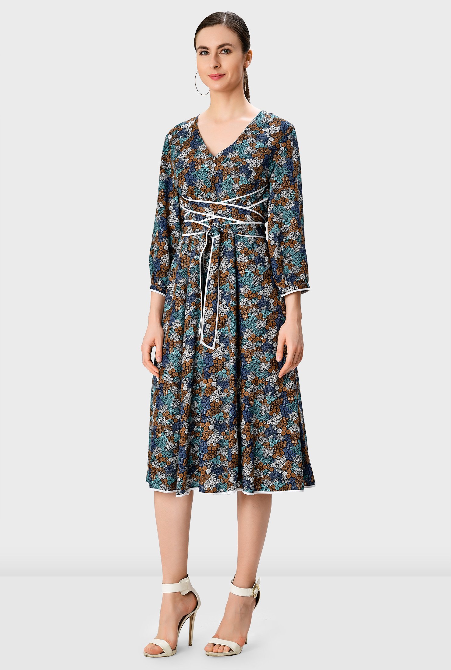 Our floral print dress is styled with attached sash ties with contrast tipped trim that wrap around the waist for a flattering finish.