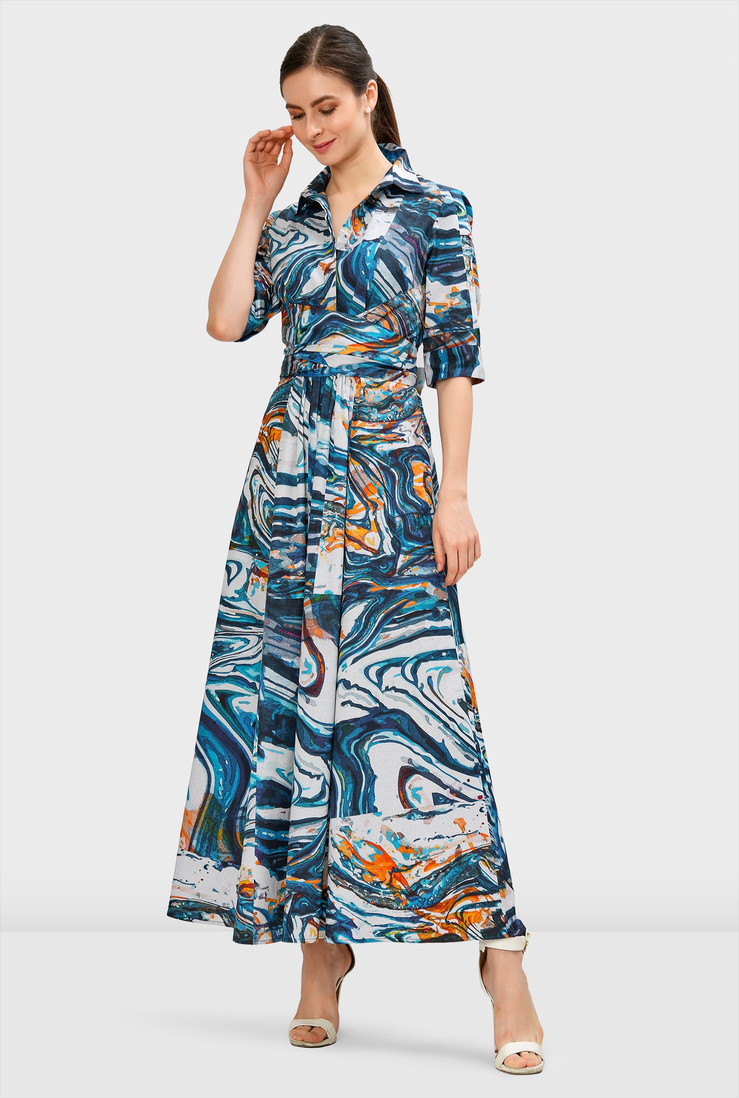 Elevate your abstract game in our chic maxi shirtdress fashioned with a smart spread collar, pleated cross-front at the empire waist and a ruched pleat full skirt.