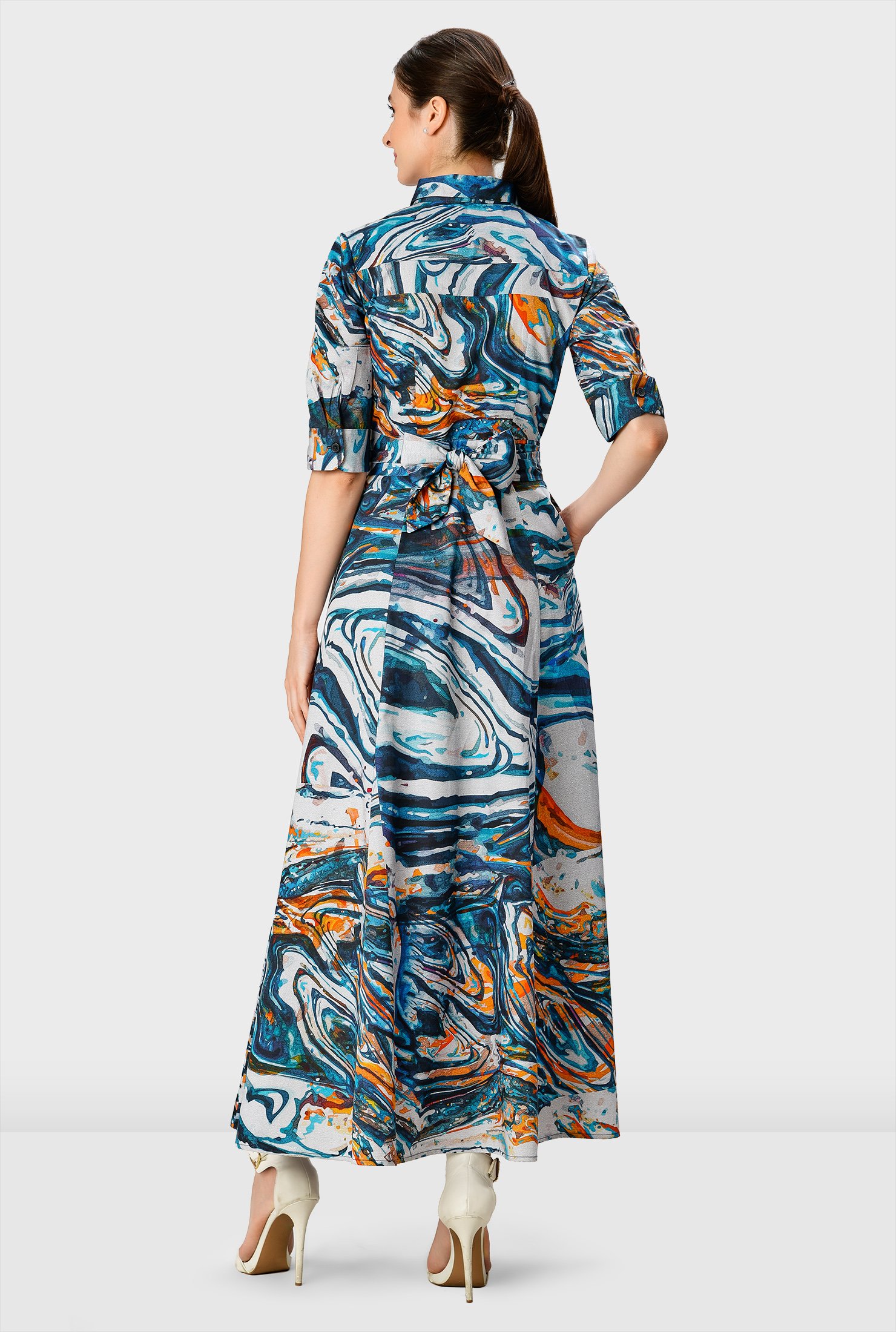 Elevate your abstract game in our chic maxi shirtdress fashioned with a smart spread collar, pleated cross-front at the empire waist and a ruched pleat full skirt.